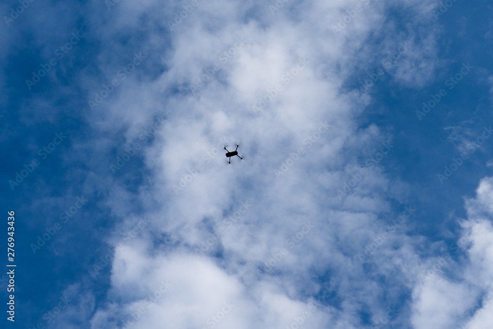 quadrocopter flying against a blue sky