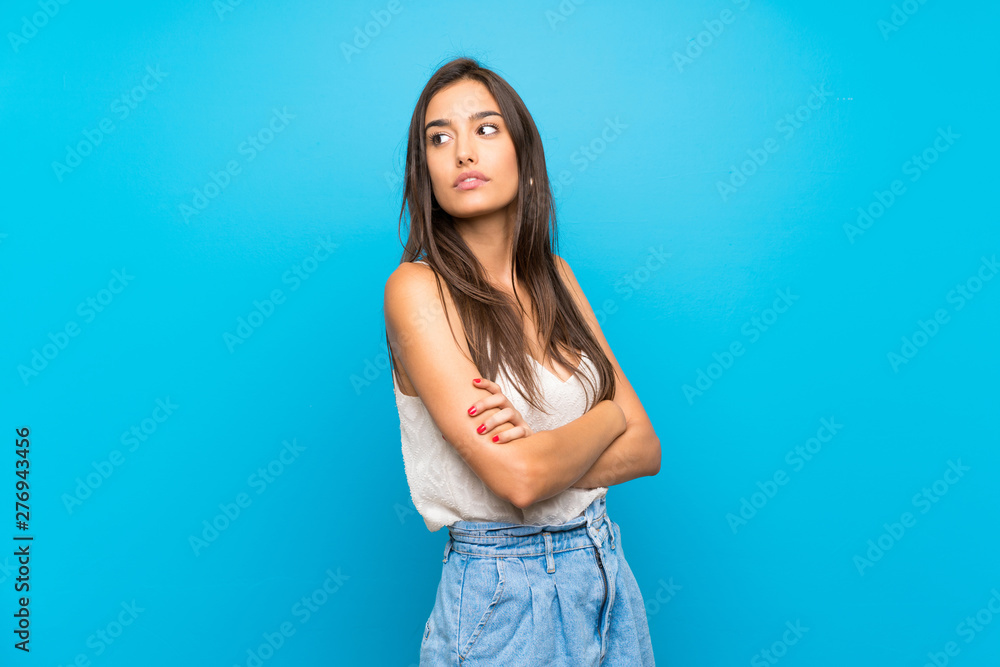 Young woman over isolated blue background portrait Young woman over isolated blue background portrait
