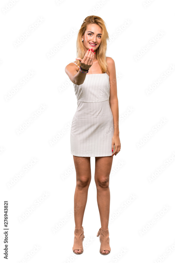 A full-length shot of a Young blonde woman inviting to come with hand. Happy that you came over isolated white background A full-length shot of a Young blonde woman inviting to come with hand. Happy that you came over isolated white background