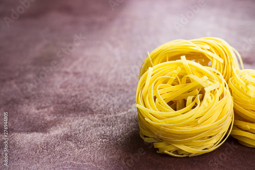 Foto Traditional italian pasta fettuccine on a wooden table