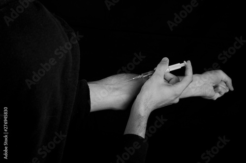 .Drugs concept Illness concept. Drug contact, young man very stressed, drug addicted young male,black and white photo