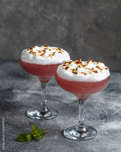 Front view of two raspberry cocktails with burned egg whites