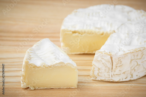 camembert soft cheese on wood background 