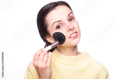 attractive girl does makeup, makeup brush