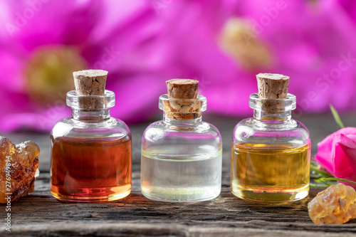 Bottles of essential oil with frankincense and Rugosa roses
