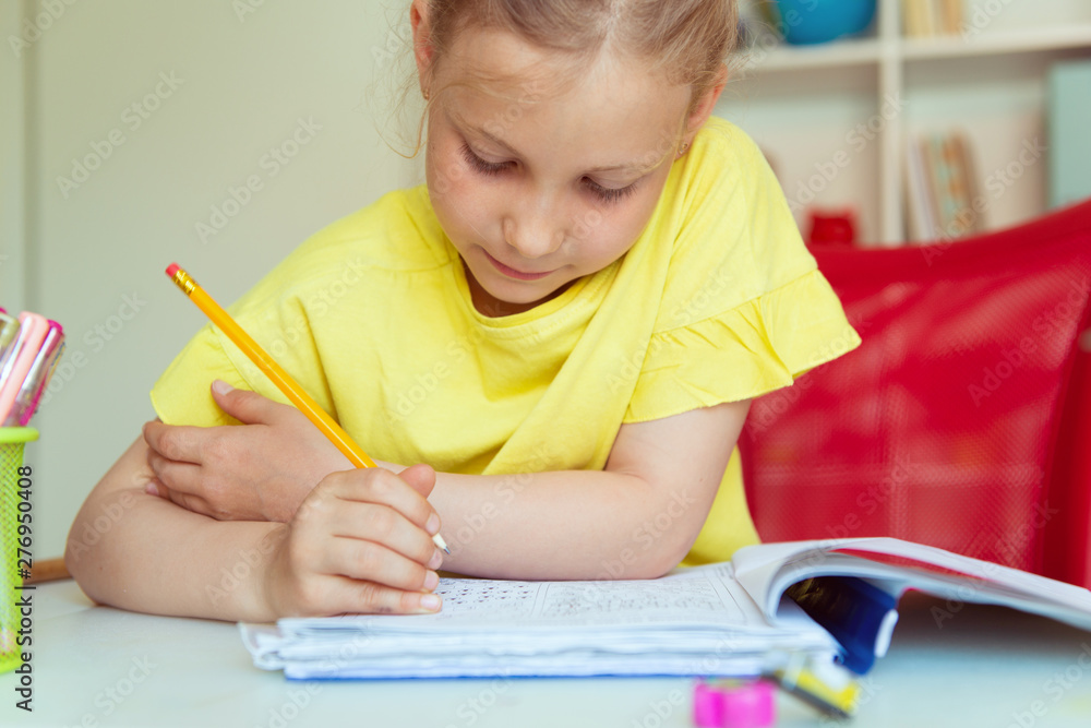 Portrait of pretty school girl are studying at classroom at the table Portrait of pretty school girl are studying at classroom at the table