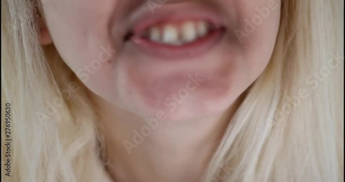 In and out of focus of woman spitting. Close up.