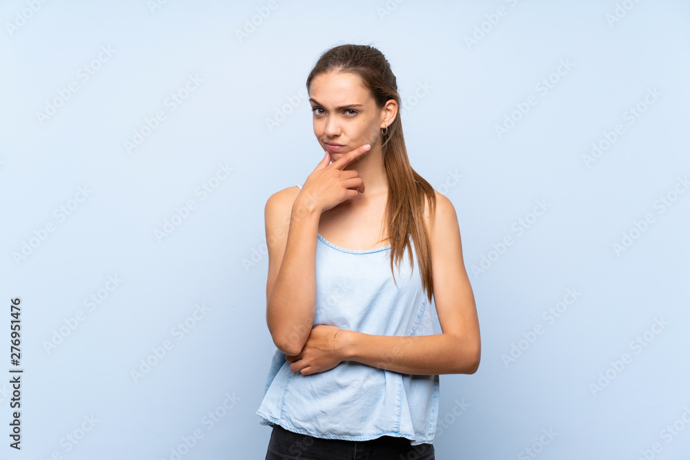 Young woman over isolated blue background thinking Young woman over isolated blue background thinking