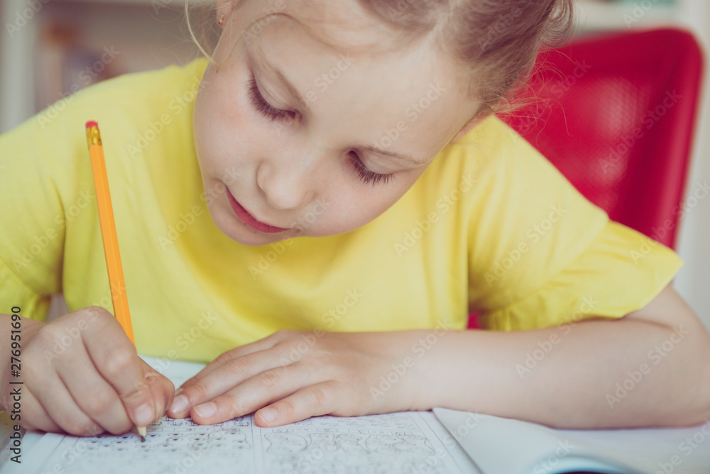 Portrait of pretty school girl are studying at classroom at the table Portrait of pretty school girl are studying at classroom at the table