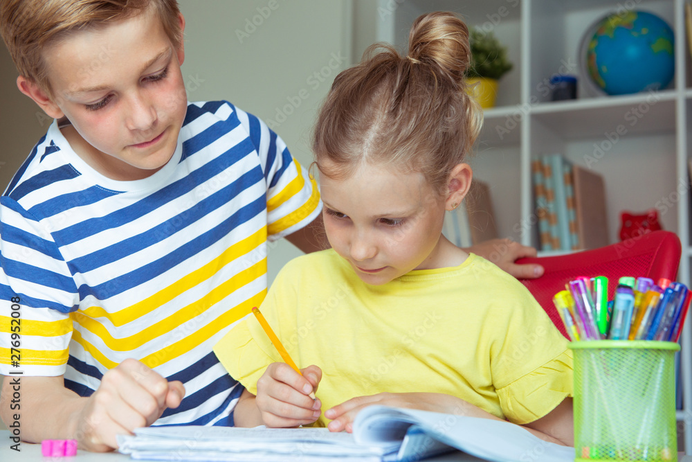 Schoolchildren are came back to school and learning at the table in classroom Schoolchildren are came back to school and learning at the table in classroom