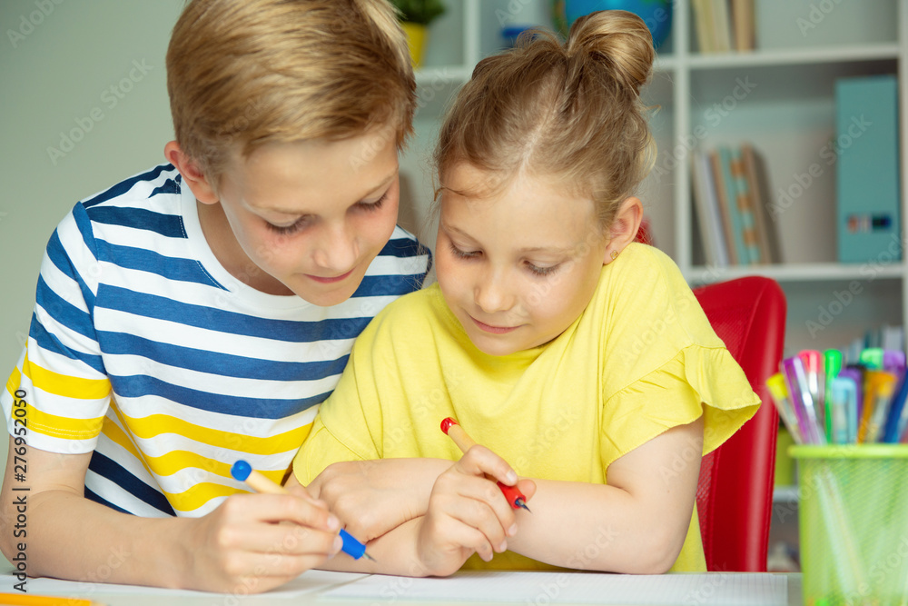 Schoolchildren are came back to school and learning at the table in classroom Schoolchildren are came back to school and learning at the table in classroom
