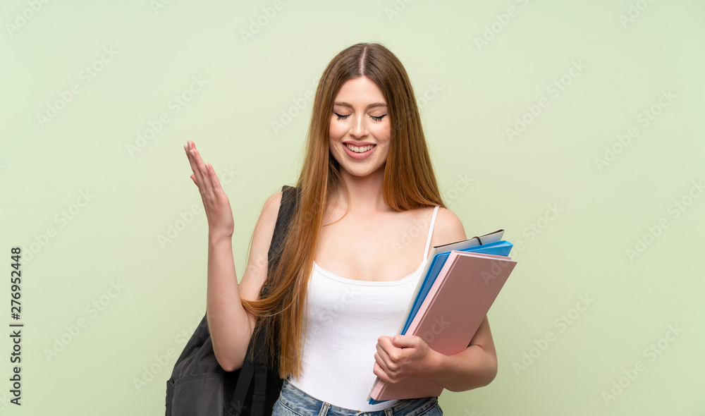 Young student woman over isolated green background laughing Young student woman over isolated green background laughing