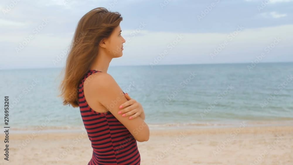 romantic girl walking on the beach, young woman on the seashore enjoying sound of surf and the wind, concept summer vacation, lifestyle romantic girl walking on the beach, young woman on the seashore enjoying sound of surf and the wind, concept summer vacation, lifestyle