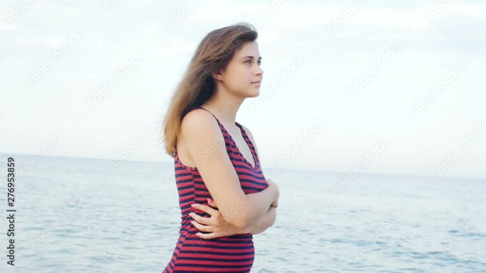romantic girl walking on the beach, young woman on the seashore enjoying sound of surf and the wind, concept summer vacation, lifestyle romantic girl walking on the beach, young woman on the seashore enjoying sound of surf and the wind, concept summer vacation, lifestyle
