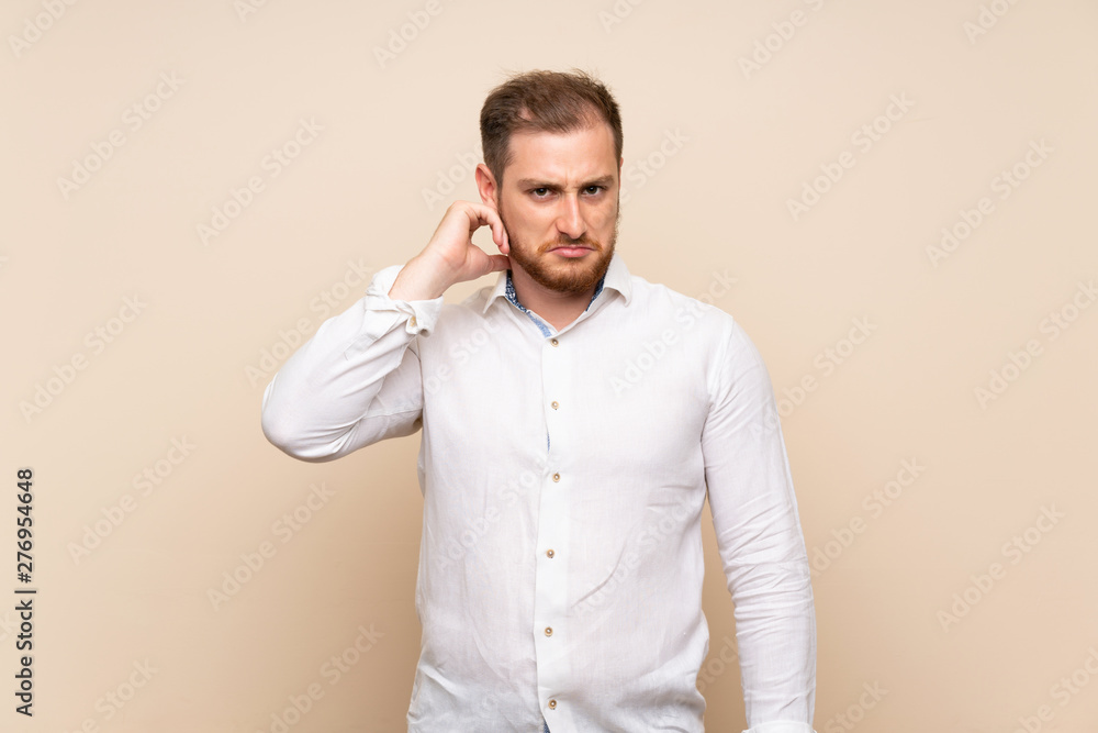 Blonde man over isolated background having doubts Blonde man over isolated background having doubts