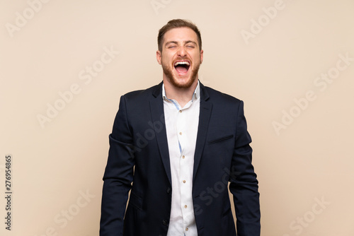 Blonde man over isolated background shouting to the front with mouth wide open