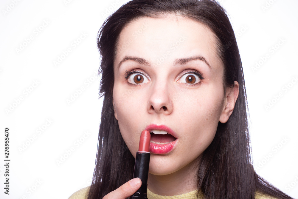 beautiful young woman paints lips with lipstick beautiful young woman paints lips with lipstick