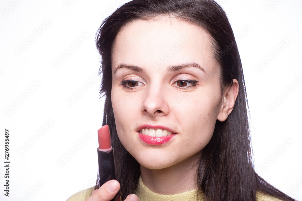 beautiful young woman paints lips with lipstick beautiful young woman paints lips with lipstick
