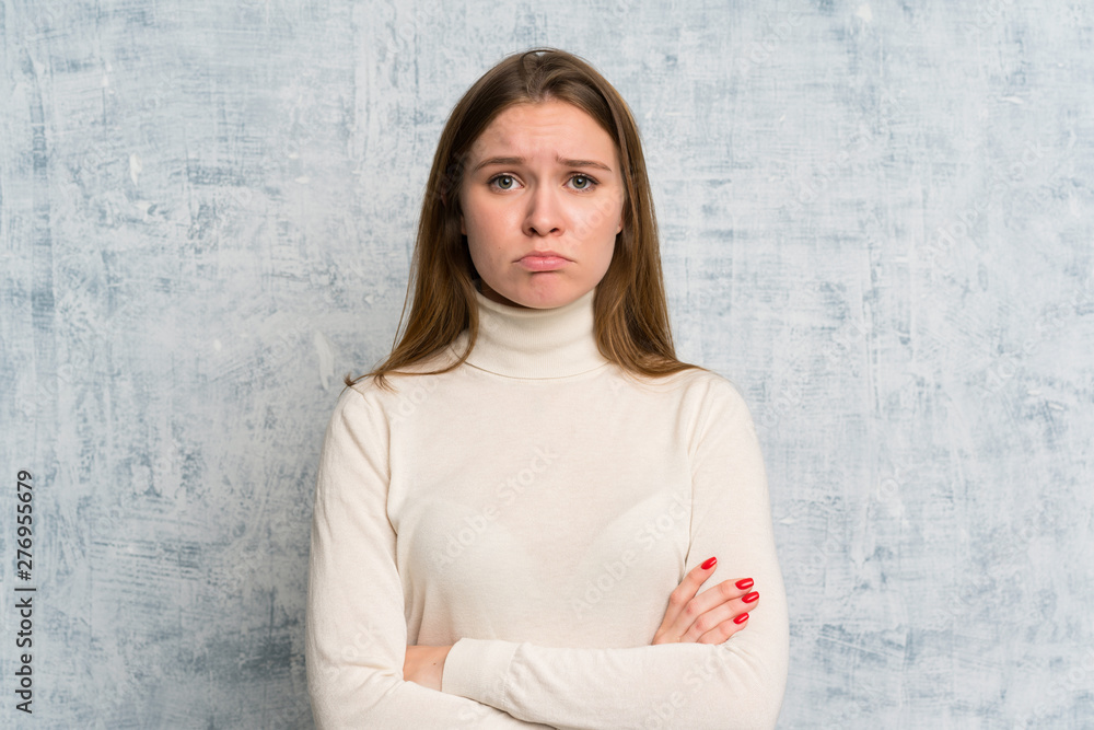 Young woman over grunge wall sad Young woman over grunge wall sad