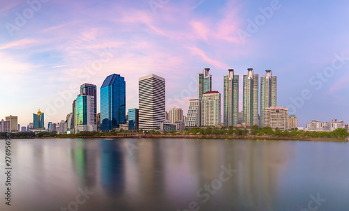 Panorama of the beautiful bityscape of office building in the evening with water reflection at Benjakitti park  Bangkok Thailand.