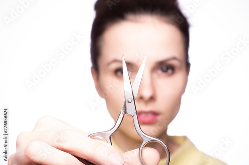 beautiful young girl holding scissors in her hands