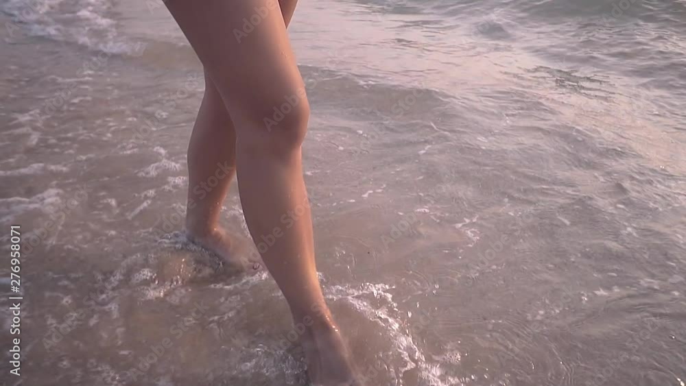 happy beautiful lady with long hair in short dress walks along pictorial tropical beach low angle shot slow motion happy beautiful lady with long hair in short dress walks along pictorial tropical beach low angle shot slow motion