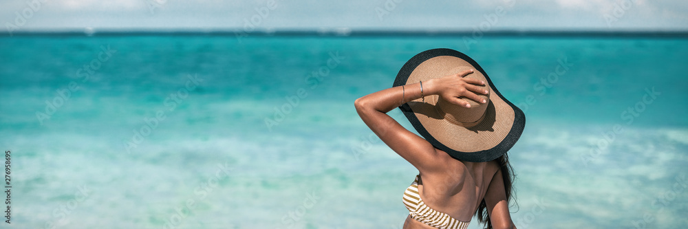 Beach suntan vacation woman relaxing wearing sun fashion floppy hat on ocean background panoramic banner. - obrazy, fototapety, plakaty 