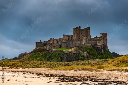 Sandy coast at low tide with Bamburgh Castle, Bamburgh, New Castele upon Tyne, Northumberland, United Kingdom, Europe photo