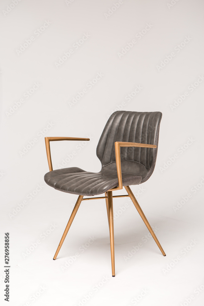 stylish grey armchair with wooden legs on a grey background stylish grey armchair with wooden legs on a grey background