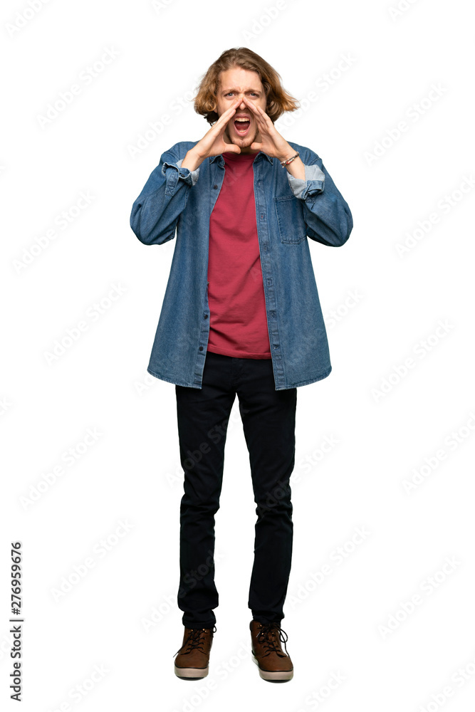 Full-length shot of Blonde man shouting and announcing something over isolated white background Full-length shot of Blonde man shouting and announcing something over isolated white background