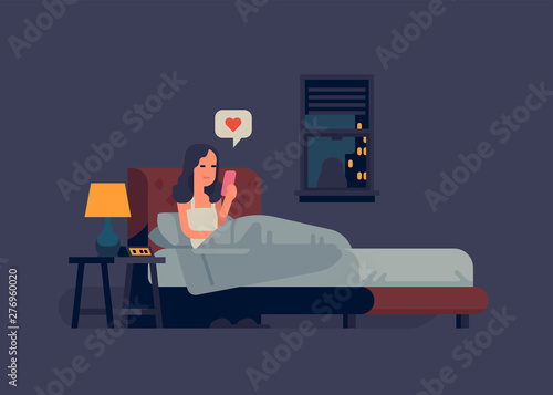Woman checking her phone in bed