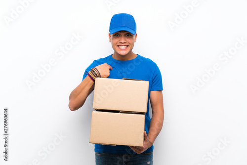 Delivery man over isolated white wall with surprise facial expression