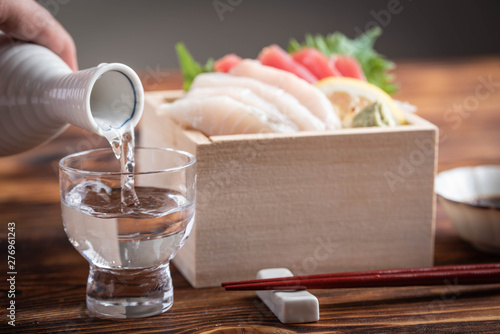 japanese sake and sashimi in wooden box, masu