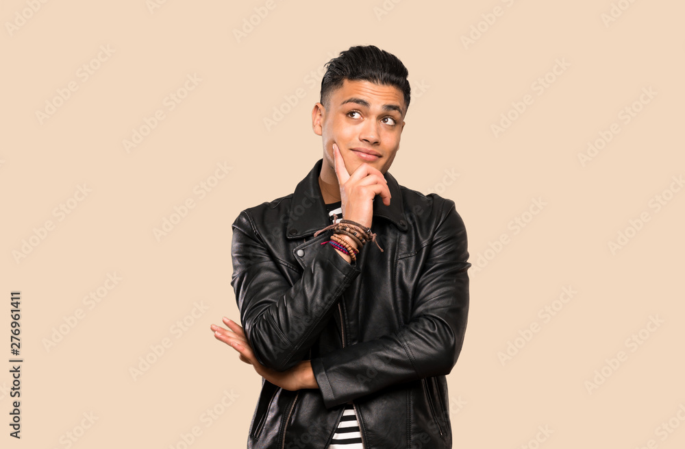 Young man thinking an idea while looking up over isolated background Young man thinking an idea while looking up over isolated background