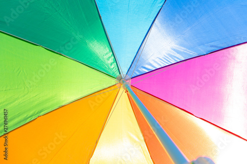 bright colorful beach umbrella for sun protection  background