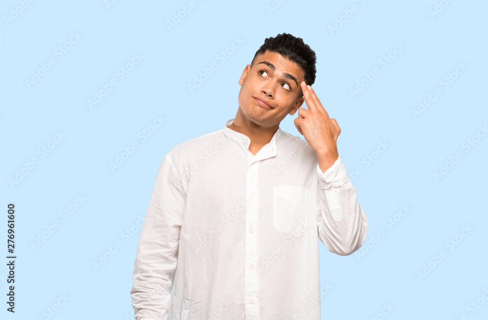 Young man with problems making suicide gesture on colorful background Young man with problems making suicide gesture on colorful background