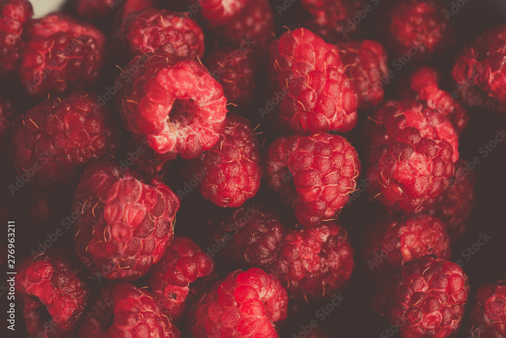 Fresh raspberries background closeup photo. Red raspberries in metal cup on wooden table. Vintage style Fresh raspberries background closeup photo. Red raspberries in metal cup on wooden table. Vintage style