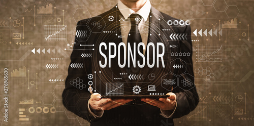 Quadro su tela Sponsor with businessman holding a tablet computer on a dark vintage background