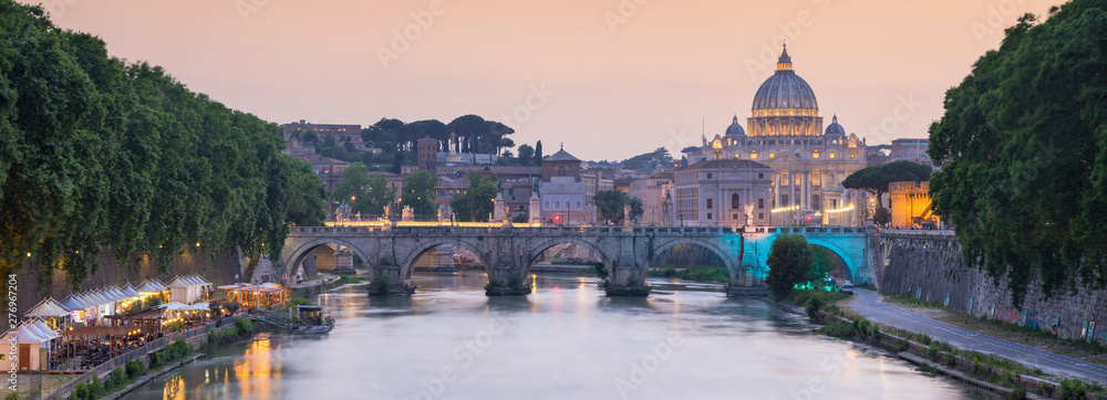 panorama of bridge and Cathedral of Saint Peter in sunset time in Rome in Italy