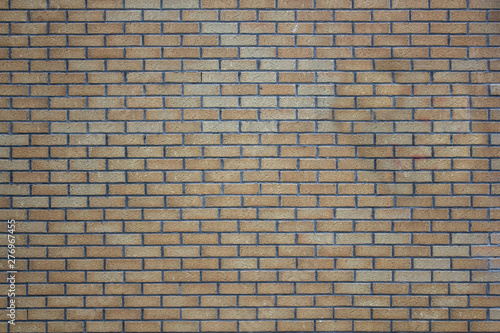 brick wall of gray and yellow bricks. rough surface texture