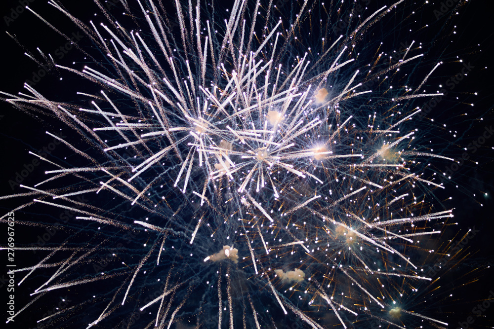 Obraz premium Cheap large sparkling fireworks, white, haze, night sky, background texture