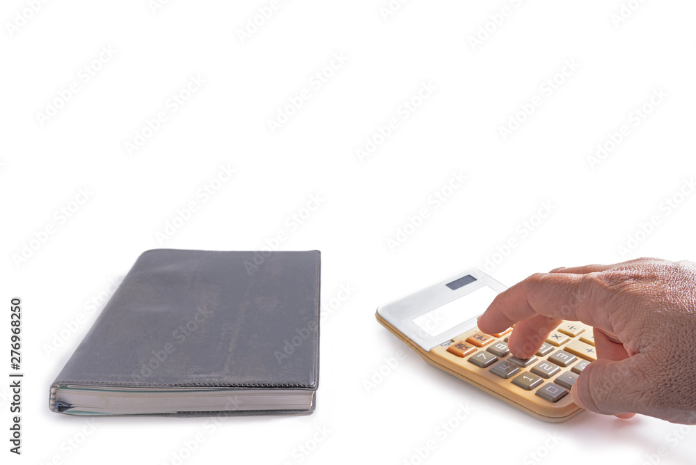 Hand using old calculator and old notebook beside on white background . Hand using old calculator and old notebook beside on white background .