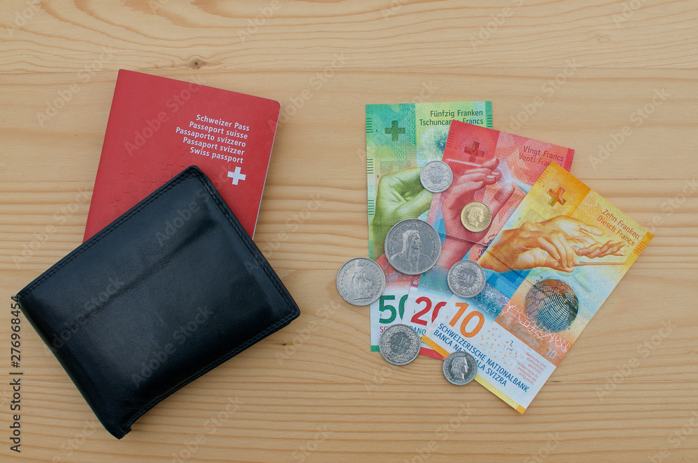 Obraz premium Black wallet with Swiss passport and swiss currency