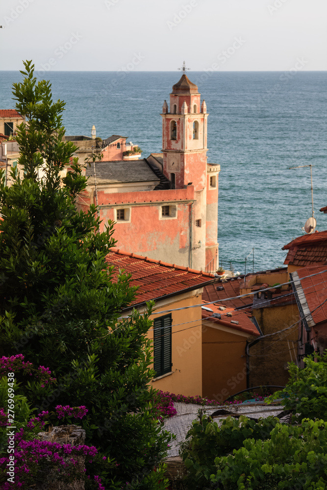 View of the pink church of Tellaro in the evening