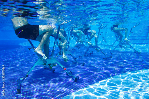 Fototapeta Naklejka Na Ścianę i Meble -  People involved in aqua aerobics on aquabikes in the pool