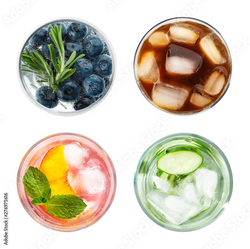 Set of glasses with different refreshing drinks on white background, top view