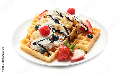 Plate with yummy waffles, whipped cream and berries on white background