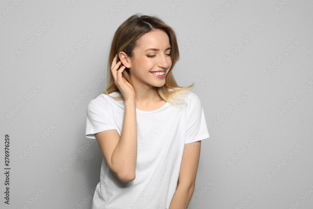Portrait of young woman with beautiful face on grey background Portrait of young woman with beautiful face on grey background