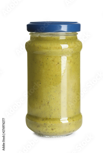 Delicious pesto sauce in glass jar on white background