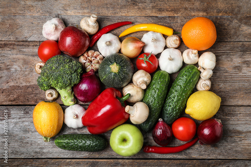Ripe fruits and vegetables on wooden table, flat lay